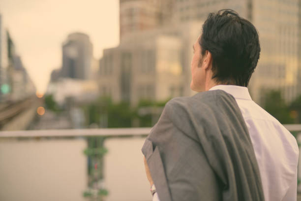 istock Rear View Of Man Looking At City 1345958989