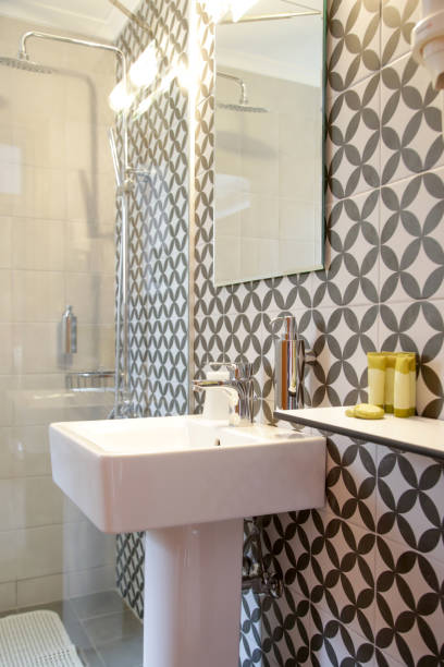 istock Modern simple bathroom with white bathroom and modern graphic ceramics 1345959806