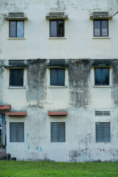 istock Dilapidated weathered old building facade. Water and mold stains 1345960222