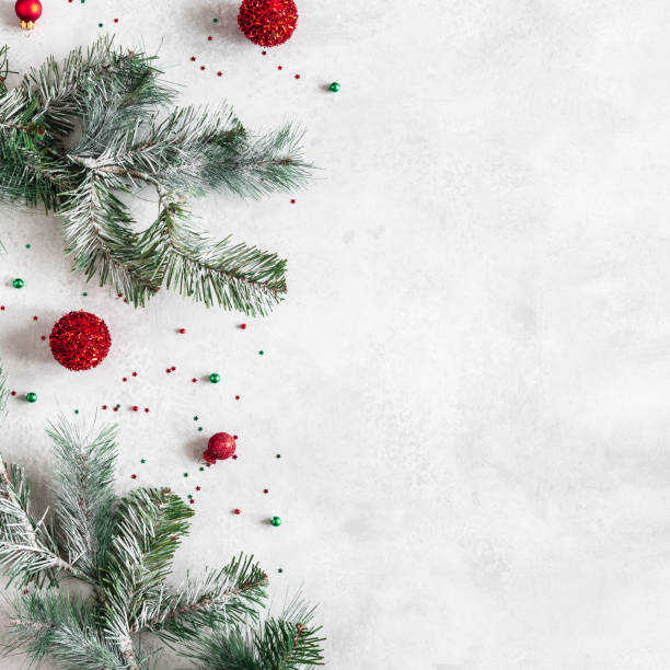istock Christmas composition. Fir tree branches, red decorations on gray background. Christmas, winter, new year concept. Flat lay, top view, copy space 1345961797