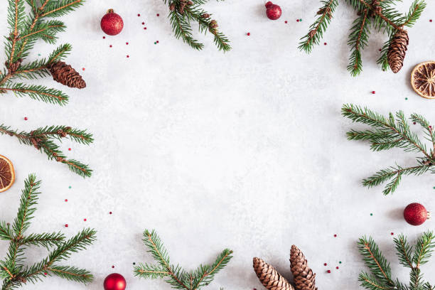 istock Christmas composition. Fir tree branches, red decorations on gray background. Christmas, winter, new year concept. Flat lay, top view, copy space 1345961800