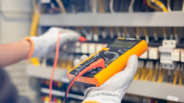 istock Electrician engineer uses a multimeter to test the electrical installation and power line current in an electrical system control cabinet. 1345962790