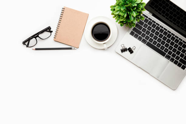 istock Flat lay, top view office table desk. Workspace with blank Laptop, office supplies, pencil, green leaf, and coffee cup on white background. 1345962865