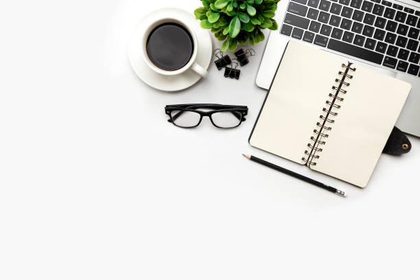istock Flat lay, top view office table desk. Workspace with blank Laptop, office supplies, pencil, green leaf, and coffee cup on white background. 1345962866