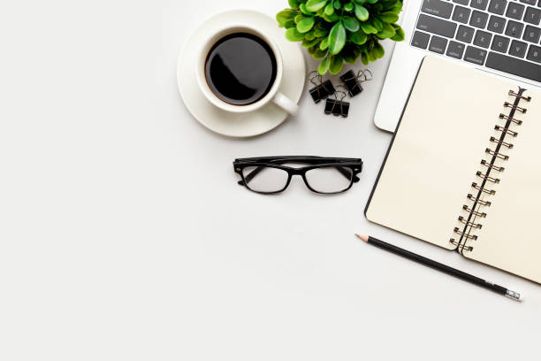 istock Flat lay, top view office table desk. Workspace with blank Laptop, office supplies, pencil, green leaf, and coffee cup on white background. 1345962867