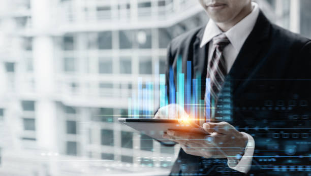 istock Businessman using tablet computer for analysis chart data of stock market 1345963892