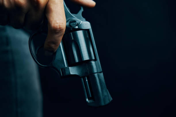 istock Black revolver with drum in man's hand. 1345964071