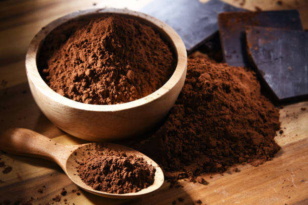 istock Composition with bowl of cocoa powder on wooden table 1345964127