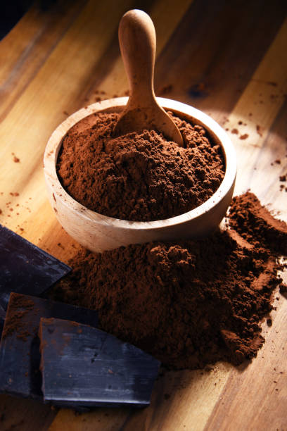 istock Composition with bowl of cocoa powder on wooden table 1345964146