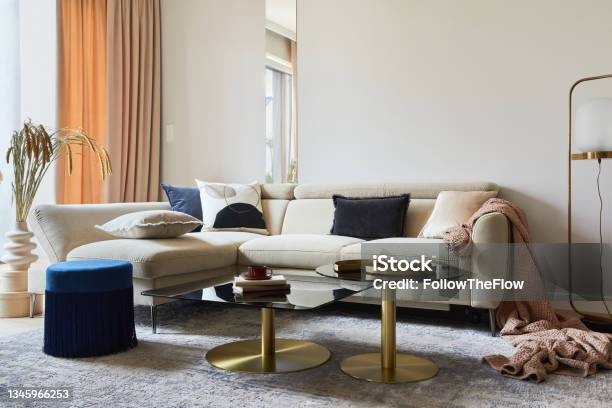 Glamorous Living Room Interior Design With Modern Beige Sofa Glass Coffee Table Red Armchair And Golden Accessories Template Stock Photo - Download Image Now