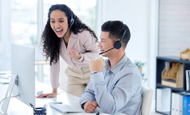 istock Shot of two young call centre agents using a computer in the office during the day 1345966601