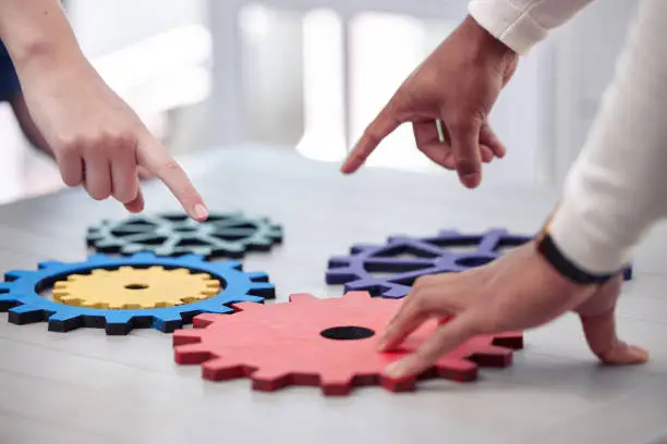 Photo of Shot of two business man working with mechanisms in a office