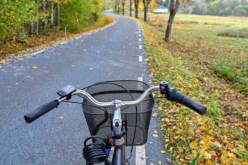 bicycle with basket ion road in autumn landscape Hallsberg Sweden october 2021