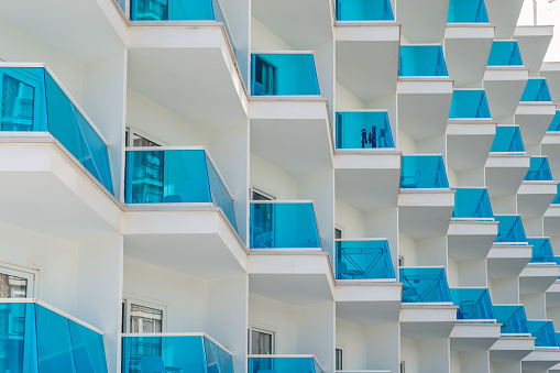 Modern white architecture with blue glass generating a geometric composition. Geometric architecture background image