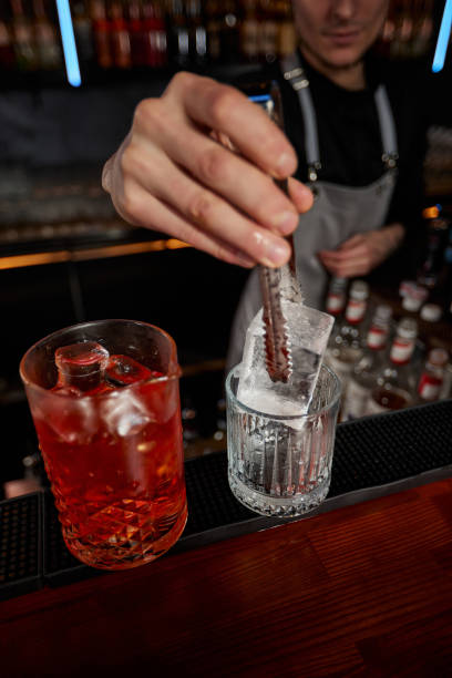 istock Barman puts the ice cubes into a glass 1345969047