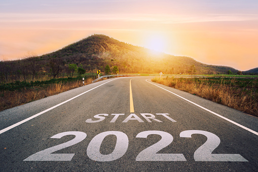 Start 2022 written on highway road in the middle of empty asphalt road of asphalt road at sunset.Concept of planning and challenge, business strategy,