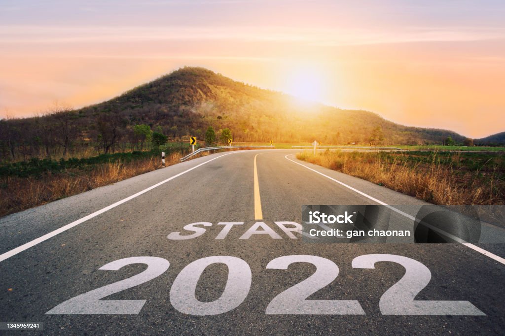 Start 2022 written on highway road in the middle of empty asphalt road of asphalt road at sunset.Concept of planning and challenge, business strategy, Start 2022 written on highway road in the middle of empty asphalt road of asphalt road at sunset.Concept of planning and challenge, business strategy, opportunity ,hope, new life change.for 2021-2022. The Way Forward Stock Photo