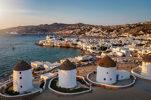 Aerial sunset view of the famous windmills above Mykonos town, Cyclades, Greece