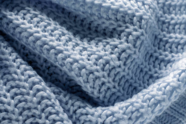 istock Background texture of blue knitted sweater. 1345971521