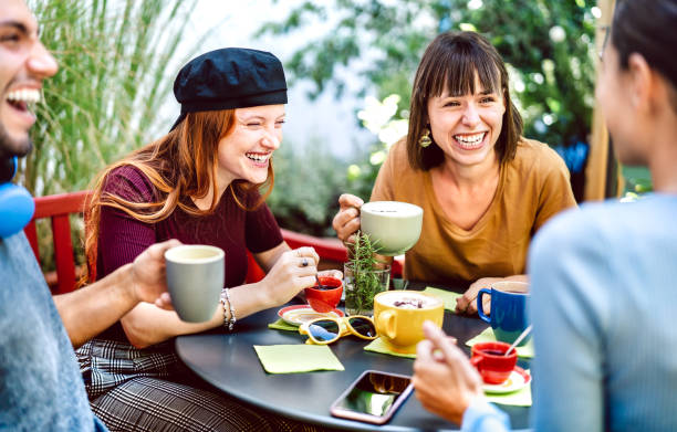Friends group drinking latte at coffee bar restaurant - Happy people talking and having fun together at hostel dehors - Life style concept with happy men and women at cafe garden - Bright vivid filter