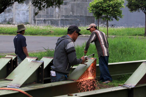 Bandung,West Java,Indonesia - Nov 12, 2012 : A welder is cutting a part of a steel structure.