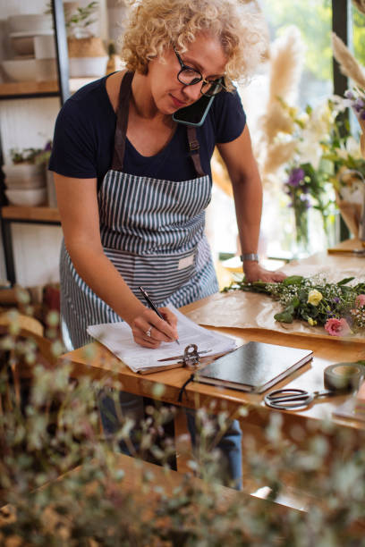 istock Making a note of her orders for the day 1345973574