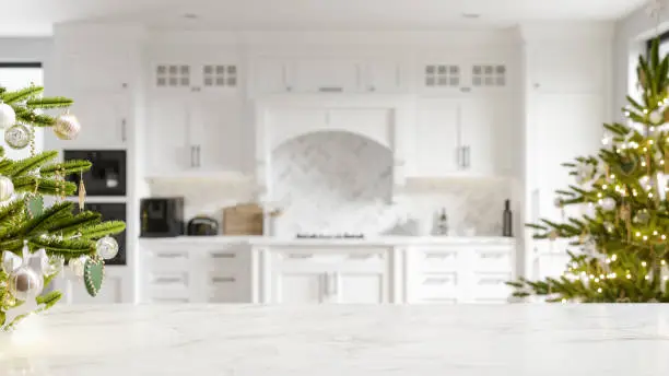 White marble countertop in a luxurious modern kitchen decorated for Christmas.
