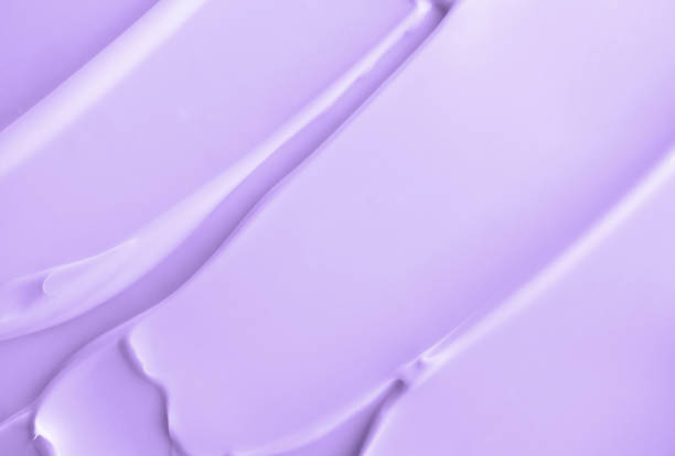 Close-up light violet cream lotion moisturiser smear smudge wavy texture. Skincare beauty product. Shampoo or hair conditioner smudge stock photo