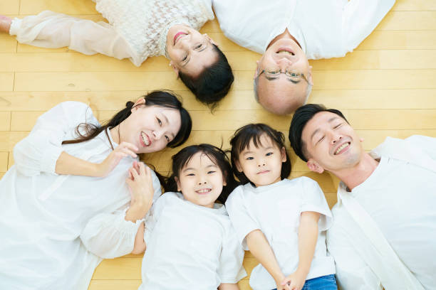 istock 3 generation family lying on the floor 1345974736
