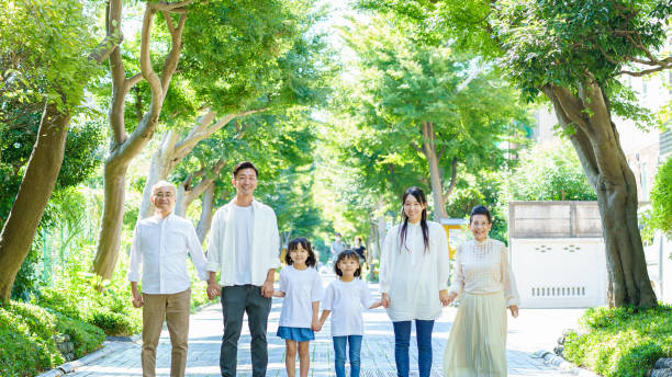 istock 3 generation family holding hands 1345974907