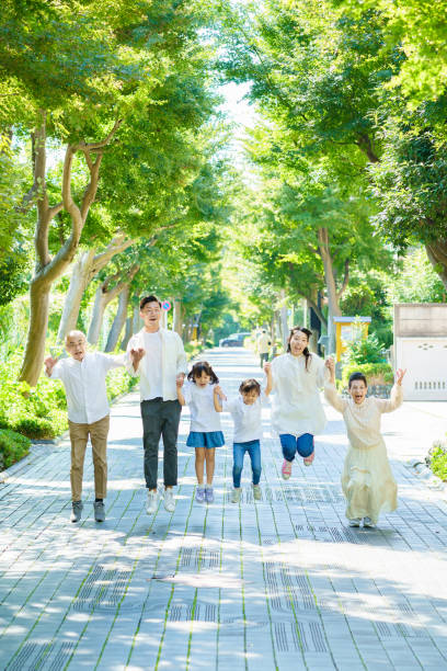 istock 3 generation family holding hands 1345974941