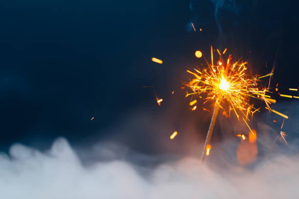 istock fire sparkler in dense smoke, abstract Christmas firework background 1345976295