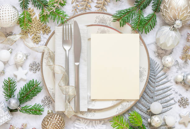 istock Festive table setting of with fir tree branches and Christmas decorations. Mockup 1345976398