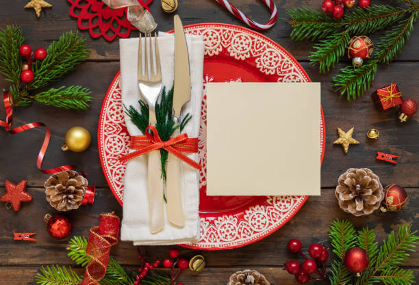 istock Festive table setting of with fir tree branches and Christmas decorations. Greeting card mockup 1345976401