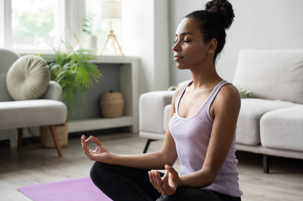 istock Woman practicing yoga, meditating at home 1345977287