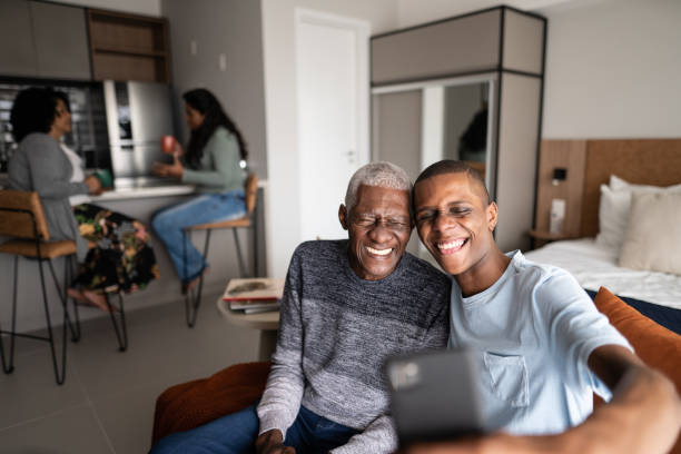 istock Grandfather and grandson taking a selfie at home 1345979933