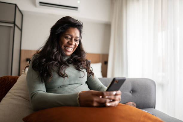 istock Mature woman using a mobile phone at home 1345980127