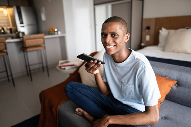 istock Portrait of a young man using a mobile phone at home 1345980139