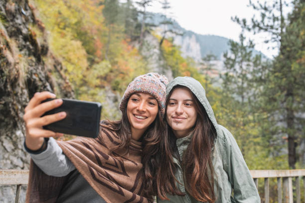 istock Two Women Taking A Selfie On Autumn Background 1345980299