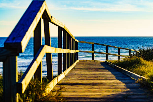 istock Beach with wooden path to sea water. 1345982996