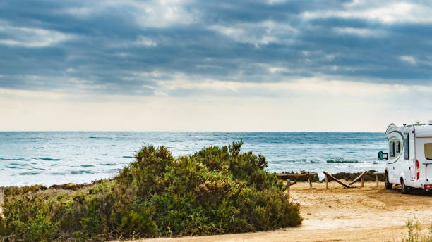 istock Camper car on beach, camping on nature 1345983726