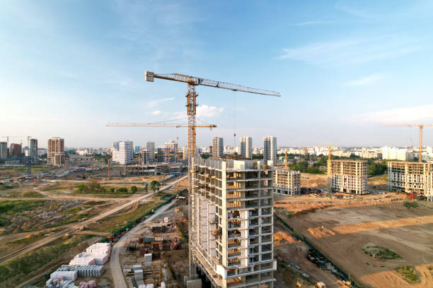 istock Crane during formworks on construction site. Pouring concrete into formwork. Construction the buildings and multi-storey residential homes. 1345985218