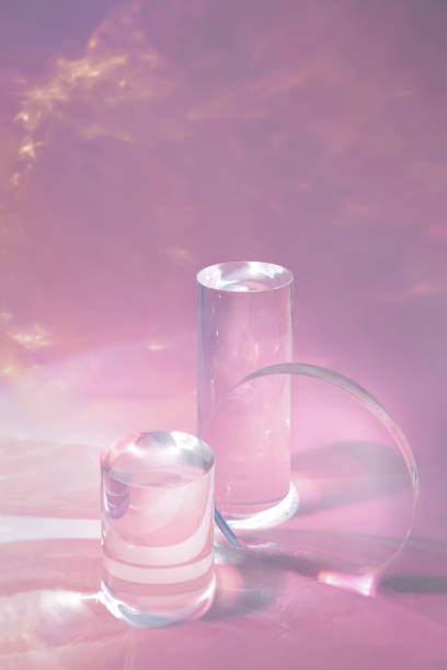 istock two clear glass cylinder podiums on pastel pink background 1345985392