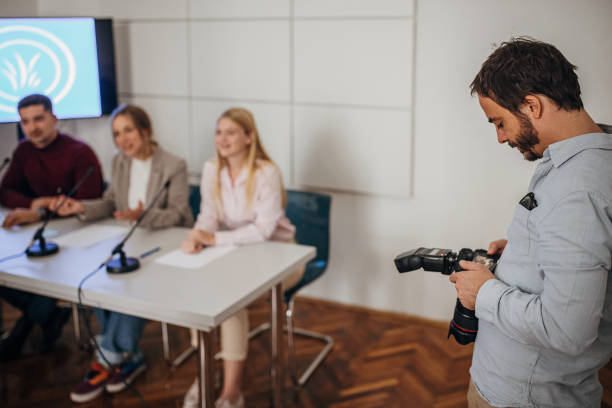 istock Photographer on press conference 1345985707