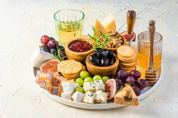 istock Cheese Platter or Cheese Board with Fruits, HErbs, Honey and Crackers 1345988686