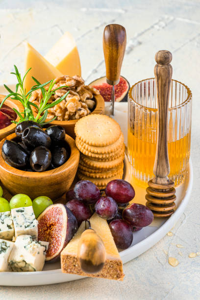 istock Cheese Platter or Cheese Board with Fruits, HErbs, Honey and Crackers 1345988829