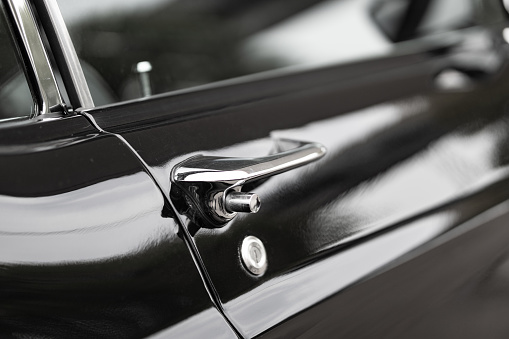 Door handle of a black colored classic American classic car