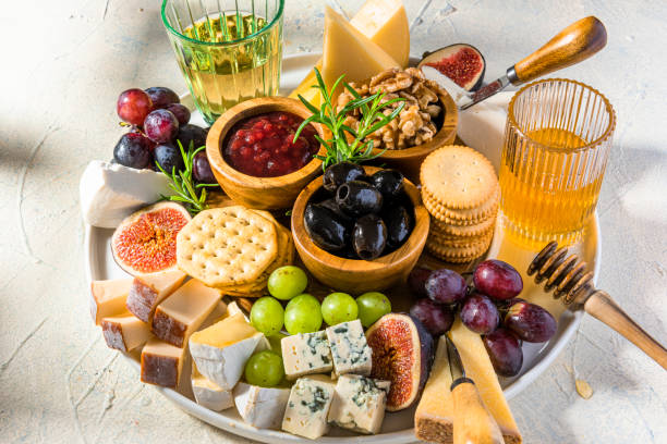 istock Cheese Board Various Cheese Olives,Figs Fruits, Grapes, Wine and Nuts 1345989683