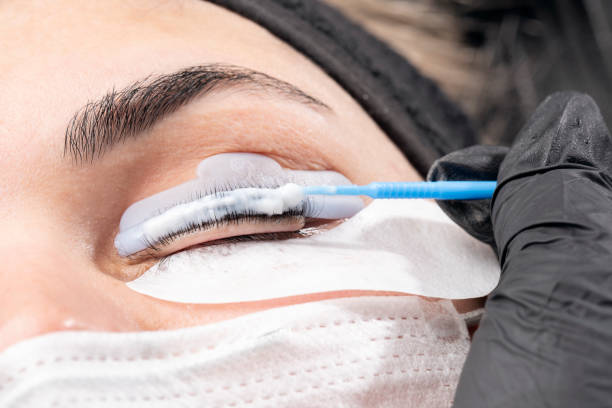Beautician is applying permanent make up Beautician is applying eyelash straightening. Beautiful young woman in beauty salon on eyebrow makeup treatment. Beautician doing eyebrows tattooing. permanent makeup before and after stock pictures, royalty-free photos & images