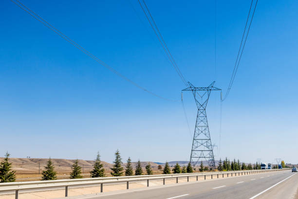 istock High voltage towers with thick hanging power cables in a rural landscape 1345990288